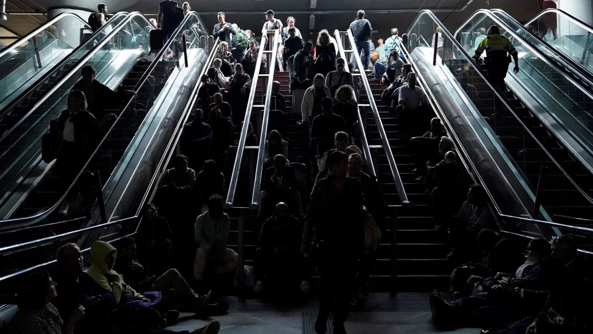 People wait on the stairs at Atocha train station in Madrid, during a massive power outage that left Spain and Portugal in the dark for hours. Ana Beltran/Reuters